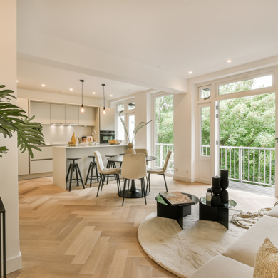 a living room with wood flooring and white walls