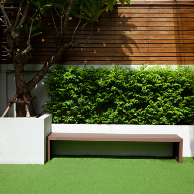 modern garden area with artificial turf and wooden bench