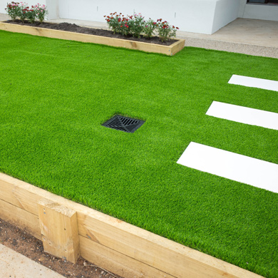 simple garden with artificial turf and cement slab path